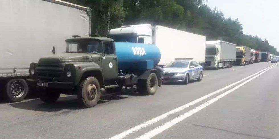 С заботой о людях: в жаркий день дальнобойщиков в очереди в "Козловичах" обеспечили водой